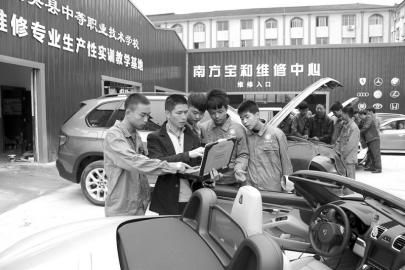 大英縣中等職業學校通過“引企入?！保瑢⑵髽I維修中心建到了校園內，圖為企業專業技師向學生講解高檔轎車的保養維修技巧。